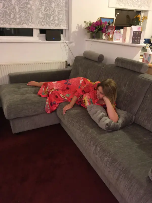 Daughter watching tv on my beautiful couch