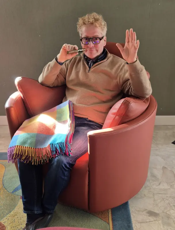 the ginger man smoking a cigar in his Fama armchair