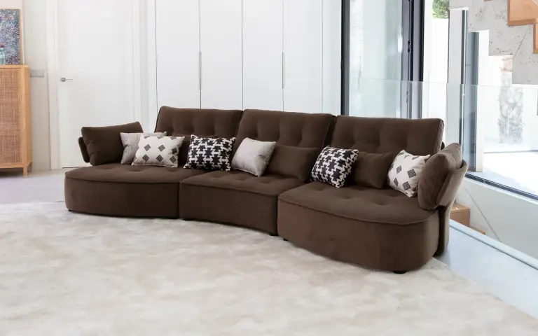 Combination of plain brown fabric and Horizon–Maya–Prisma cushions, featuring soft black and beige patterns on a neutral background.