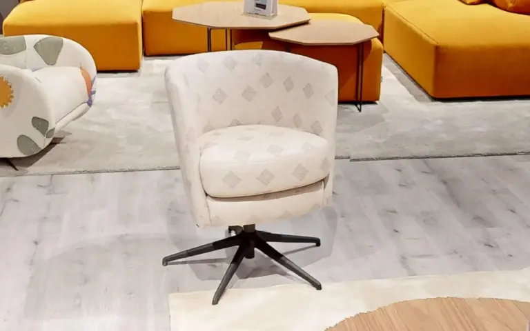 Swivel armchair upholstered in beige Horizon–Maya–Prisma fabric with ethnic motifs on a natural off-white background.